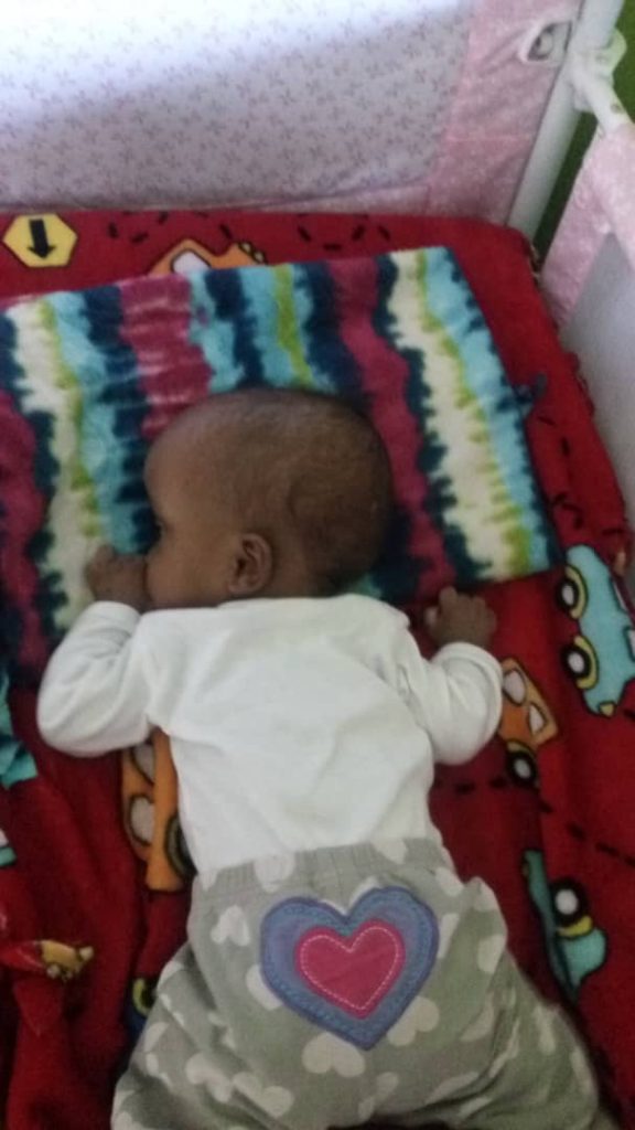 Infant asleep in a crib