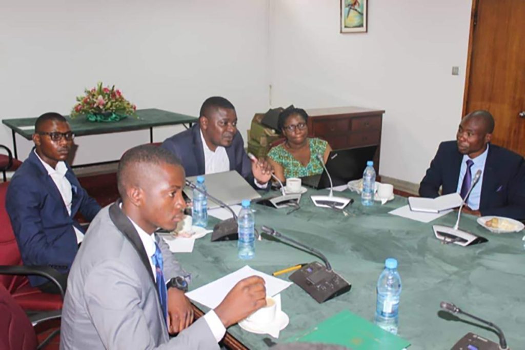 Group of people at a meeting using microphones