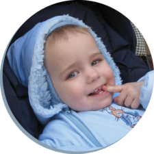 Young boy from Belarus smiling with a finger in his mouth