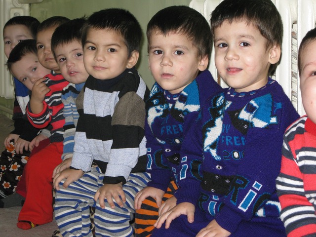 A group of boys in Tajikistan sitting in a row