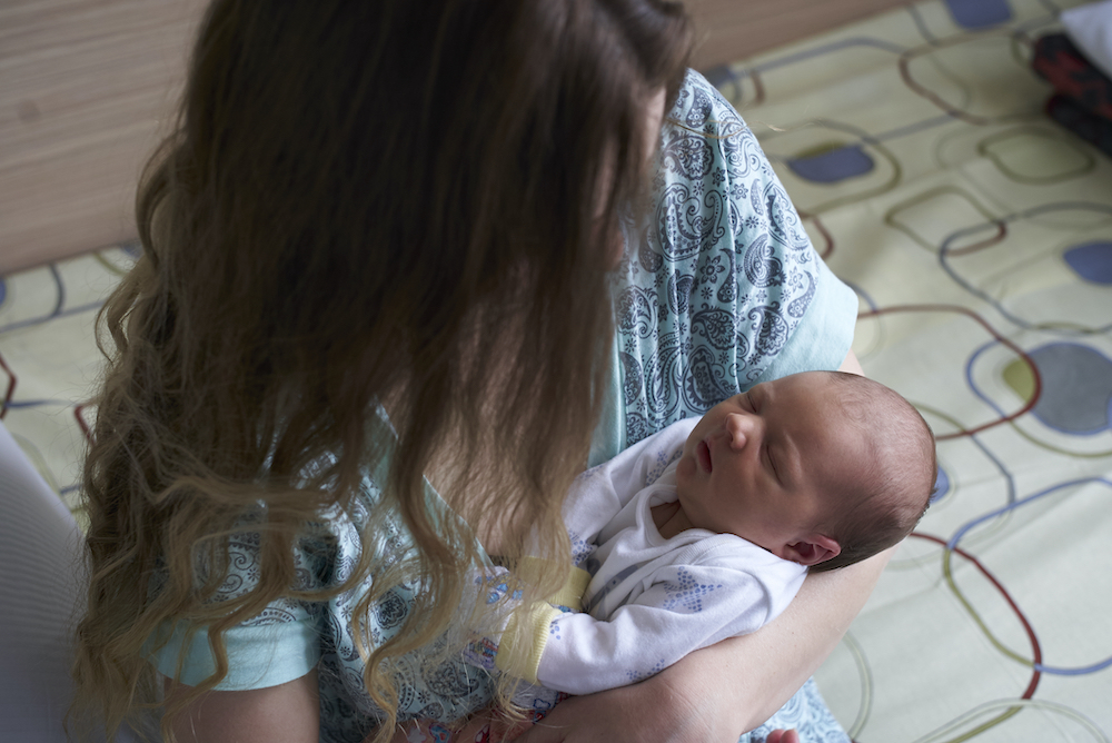 Caregiver holding a newborn baby