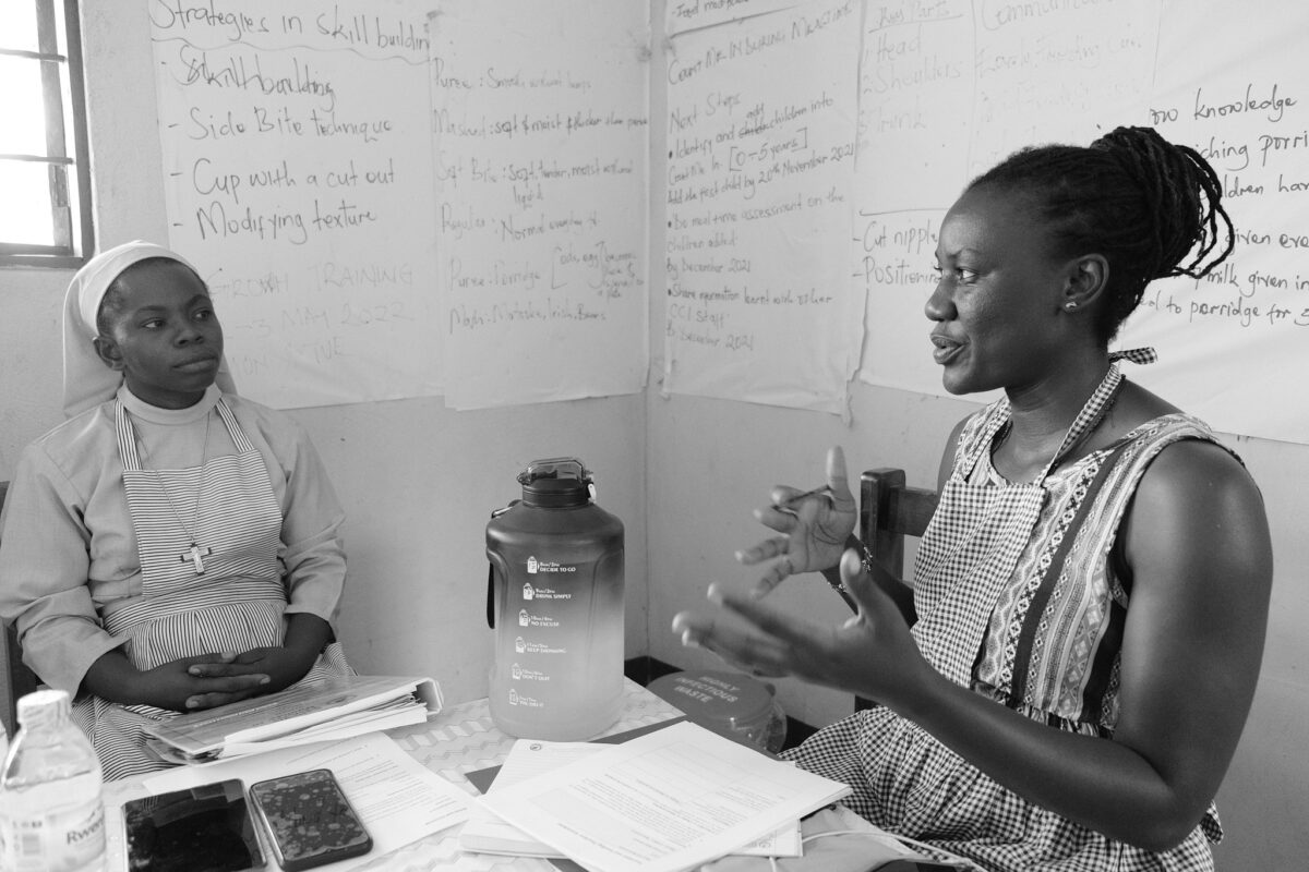 Master Trainer speaking with a Catholic Sister at a site in Uganda